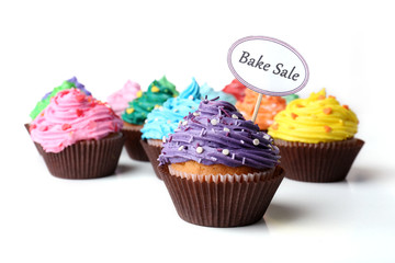Delicious cupcakes with inscription isolated on white
