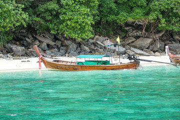 Naklejka na ściany i meble Traditional longtail boat in bay on Phi Phi Island,Thailand
