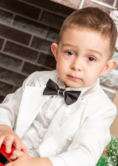 Boy gentleman by fireplace. Christmas and New Year