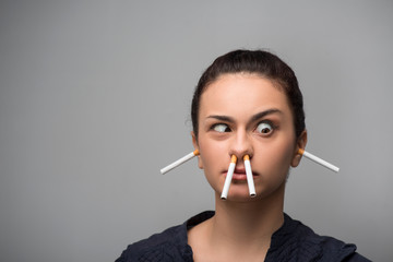 Addiction. Closeup of young attractive woman with cigarettes. Qu