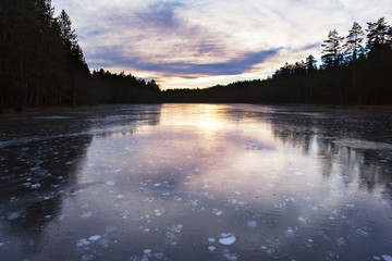 Idyllic and icy lake in sunset