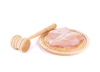 Chicken fillets on platter with hammer.