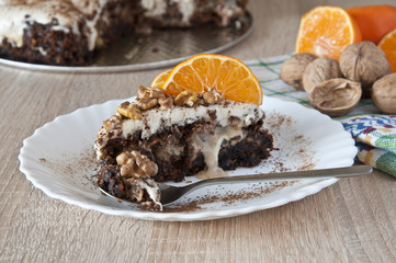 carrot cake sprinkled with walnuts and mandarine slices