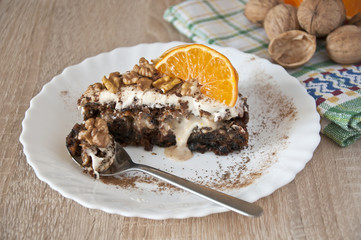 carrot cake sprinkled with walnuts and mandarine slices
