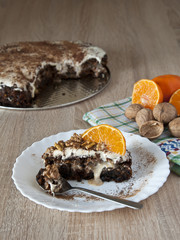 carrot cake sprinkled with walnuts and mandarine slices