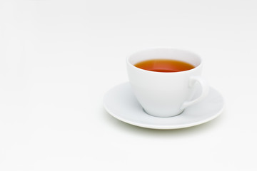 Classic white cup of black tea on white table