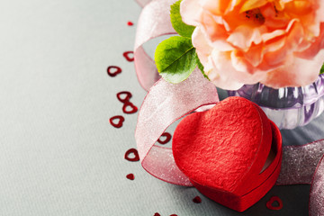 Fototapeta na wymiar Heart shaped gift box and rose in vase, Valentine's Day concept