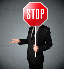 Businessman holding a stop sign