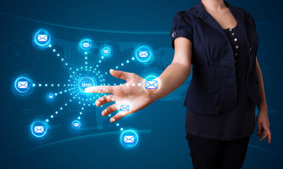 Woman pressing virtual messaging type of icons