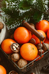 Xmas decoration wih tangerines, nuts and pine tree twigs