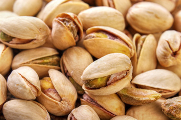 Salted and roasted pistachio nuts background