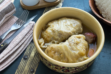 Stuffed cabbage rolls with minced meat in ceramic bowl