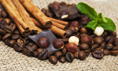Coffee beans with cinnamon sticks and chocolate