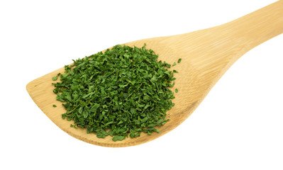 Parsley flakes on a wood spoon