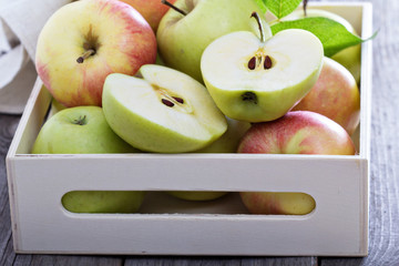Fresh apples in a wooden box