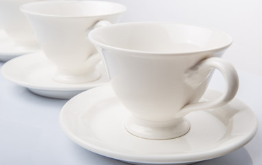 Obraz na płótnie Canvas Ceramic saucer and teacup over white background 
