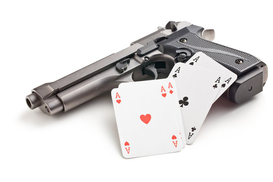 handgun and poker cards