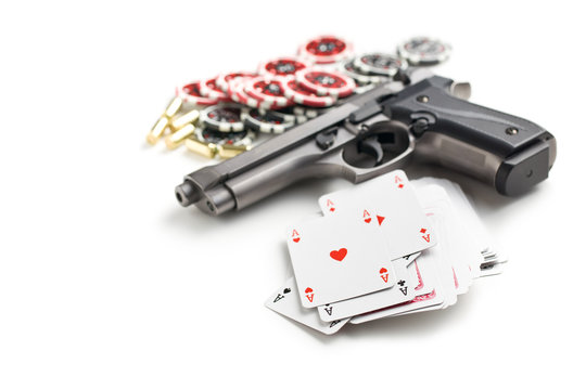 handgun and poker cards