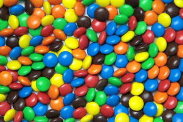 Colorful dragee candies as background.
