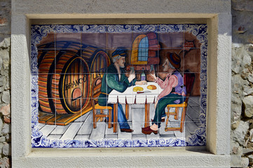 Tiles with two men drinking in Alte, Portugal