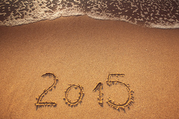 New year 2015 written in sand
