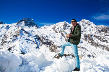 Fototapeta na wymiar Tourist on the background of snowy mountains
