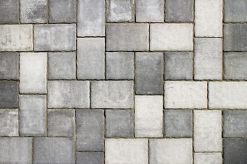 Part of urban street covered with gray concrete cubes