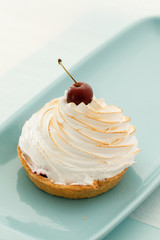 Pavlova cake with cherry