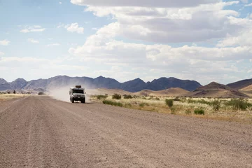 Wandaufkleber Driving in a dirt road © Morenovel