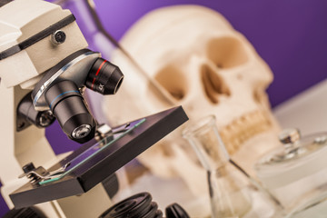 laboratory microscope and human scull