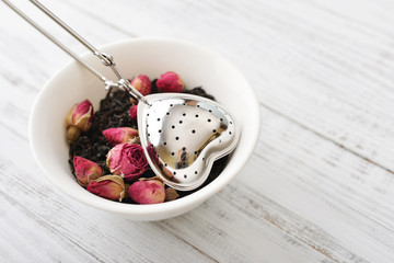 Tea strainer and rose buds