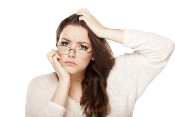 confused young woman scratching her head