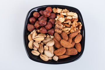 Fototapeta premium Assorted nuts in ceramic bowl