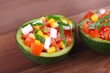 Tasty salad in avocado on table close-up