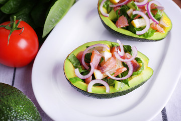 Tasty salad in avocado on plate table close-up