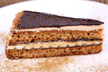 Delicious chocolate cake on plate on table close-up