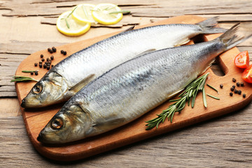 Fresh raw fish and food ingredients on table
