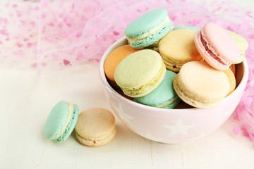 Assortment of gentle colorful macaroons in colorful bowl