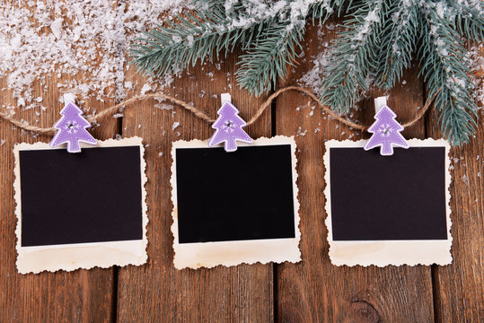 Blank photo frames and Christmas decor with snow fir tree