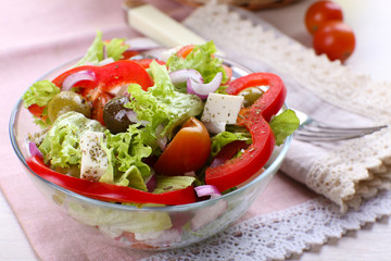 Greek salad in glass dish with fork