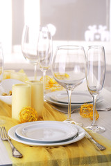 Beautiful holiday table setting in white and gold color