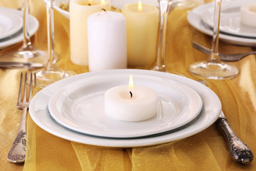 Beautiful holiday table setting in white and gold color