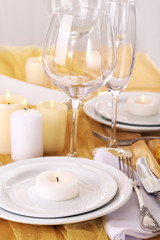 Beautiful holiday table setting in white and gold color
