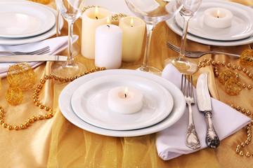Beautiful holiday table setting in white and gold color
