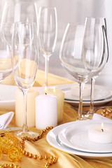 Beautiful holiday table setting in white and gold color