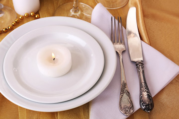 Beautiful holiday table setting in white and gold color