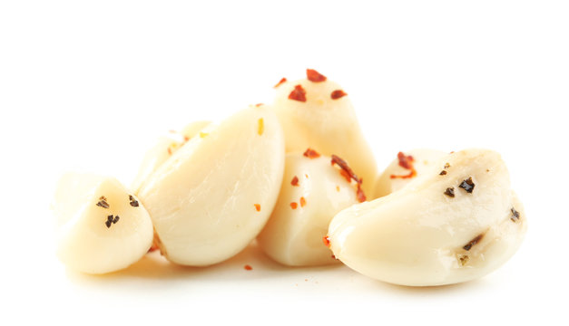 Canned garlic in bowl, isolated on white