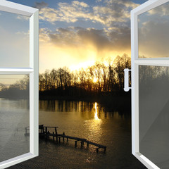window opened to the river with sunset