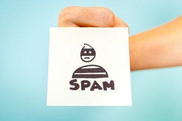 Sketch note with the word SPAM sticked on fist, on blue background. Email problem concept.