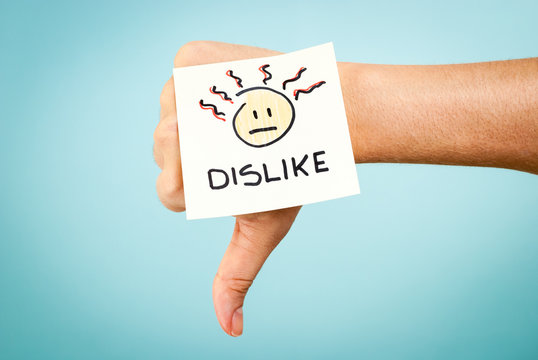 Dislike concept with hand on blue background